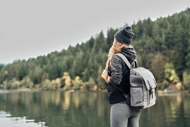 istock Young beautiful woman enjoying nature and lakes 1138439421