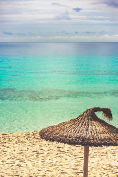 istock Parasol on beach with turquoise sea 1138439869