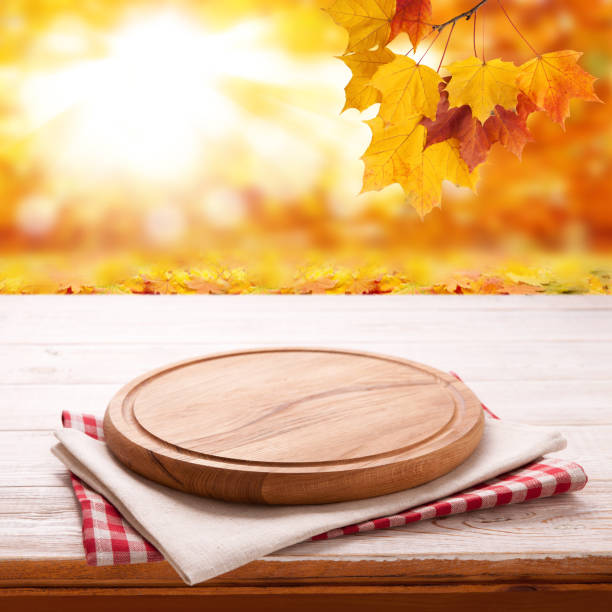 istock Pizza board, with tablecloth on wooden table and autumn background. . Top view mockup 1138440235