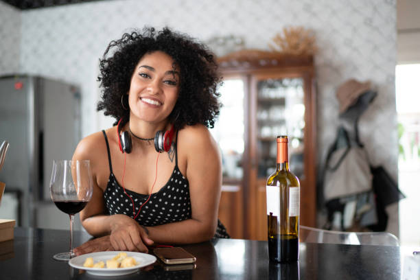 istock Woman portrait drinking wine at home 1138440480