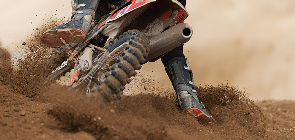 Man, motorcycle and desert race with speed, freedom and goal for sports with sand terrain in nature. Motorbike, guy riding and start for extreme sport, training and mockup space for challenge in sand