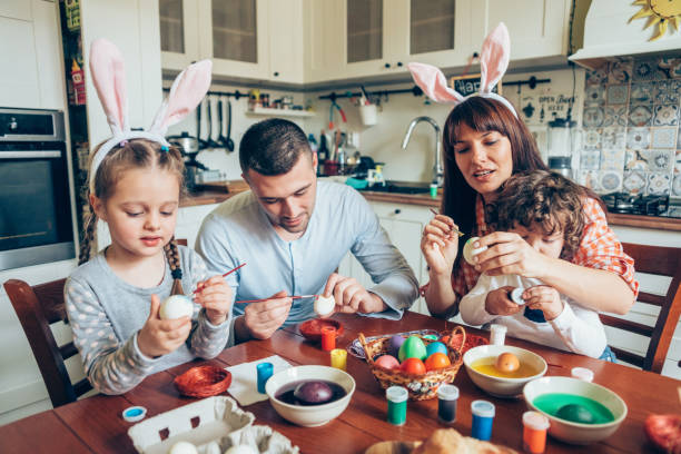 istock Happy family painting Easter eggs 1138441370