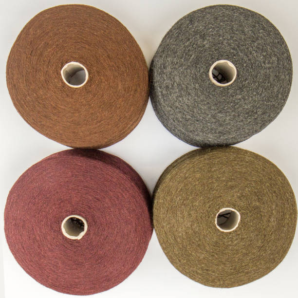 istock multi-colored bobbins of yarn on a white background. View from above 1138442970