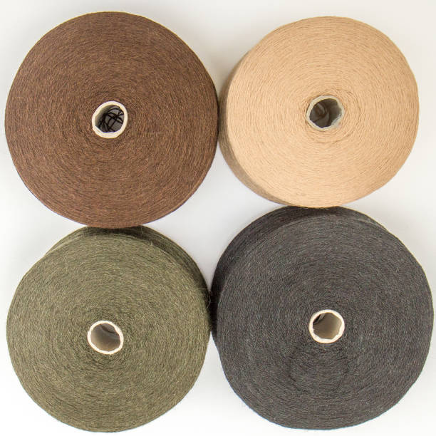 istock multi-colored bobbins of yarn on a white background. View from above 1138442972