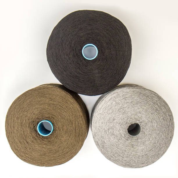 istock multi-colored bobbins of yarn on a white background. View from above 1138442975