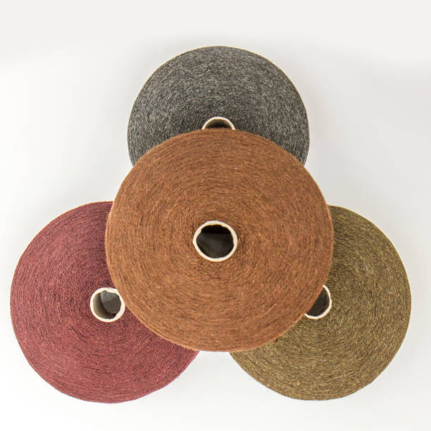 istock multi-colored bobbins of yarn on a white background. View from above 1138443002