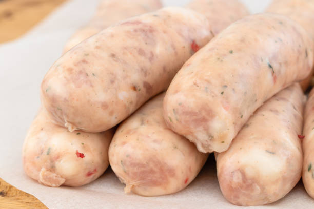 istock Fresh raw sausage on the wooden background 1138443414