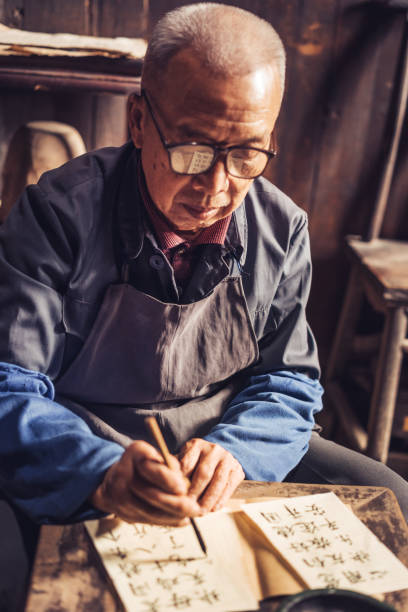 istock Chinese senior man writing chinese calligraphy 1138444378