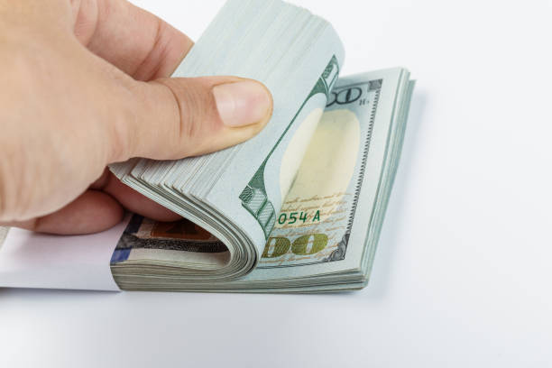 istock woman hand with dollars isolated on a white background 1138444477