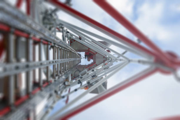 rope access technician climbing on the tower - antenna with hooks and looking down - high frequencies imagens e fotografias de stock