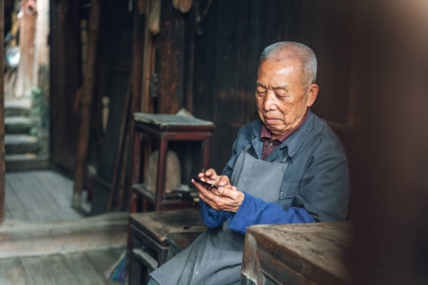 istock Chinese senior man using mobile phone 1138444756