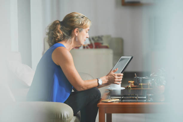 istock Mature woman with digital tablet 1138444919