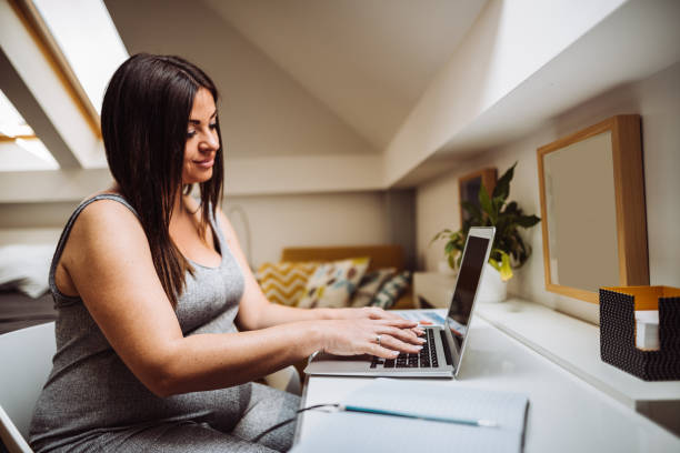 istock pregnant woman working at home 1138448806