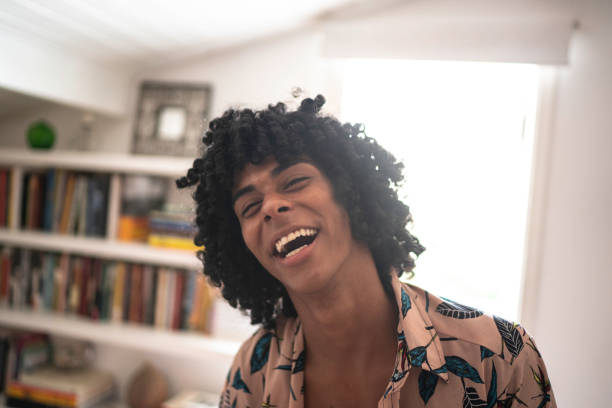 istock Young man laughing at home 1138449550
