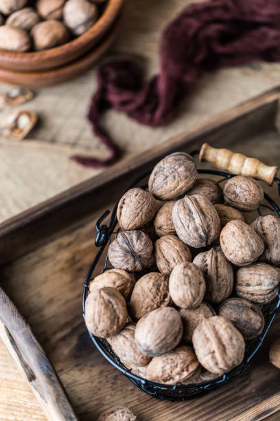 istock Walnuts on rustic wooden background. Food, nuts background. Print for kitchen 1138451240