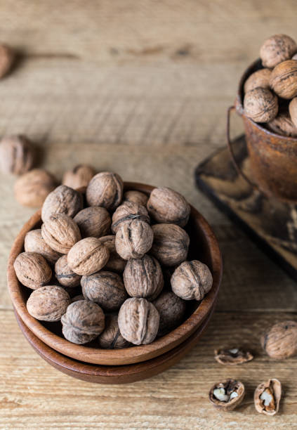 istock Walnuts on rustic wooden background. Food, nuts background. Print for kitchen 1138451316