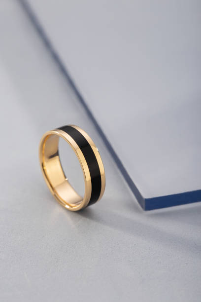 istock Gold ring with black enamel on blue background 1138454819