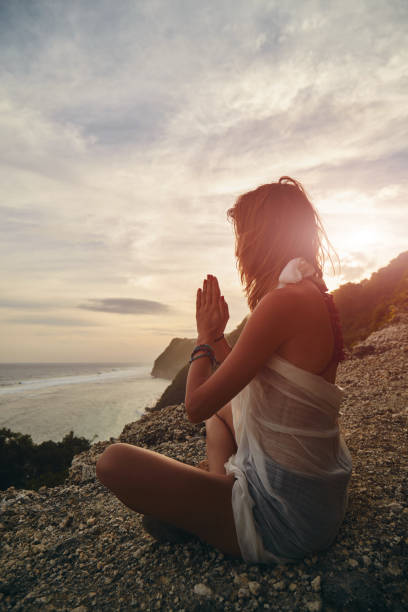 istock Young woman practicing yoga - meditation on the beach. 1138456940