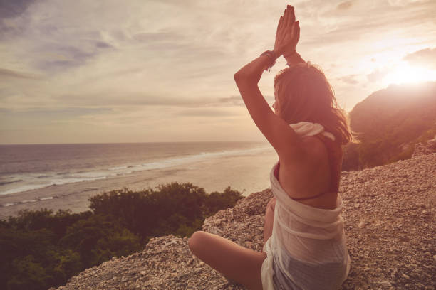 istock Young woman practicing yoga - meditation on the beach. 1138457022