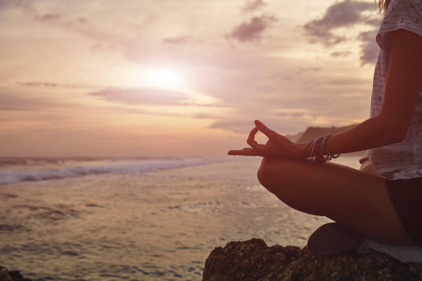 istock Young woman practicing yoga - meditation on the beach. 1138457565