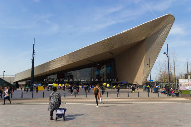 Modern architecure of Rotterdam central station Rotterdam, the Netherlands - April 7 2018: Modern architecure of Rotterdam central station with passengers and tourists walking to and from the entrance tasrail stock pictures, royalty-free photos & images