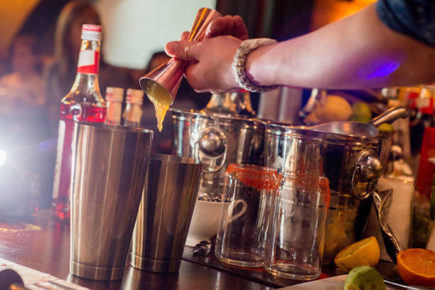 istock barman preparing cocktail in a cocktail bar andr pours liquid into the jigger. 1138457996