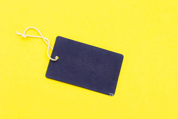 istock empty cardboard paper gift tag isolated on yellow background 1138459721