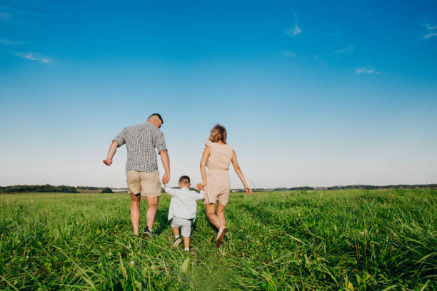 istock Happy boy with parents running in park. Summertime 1138462293