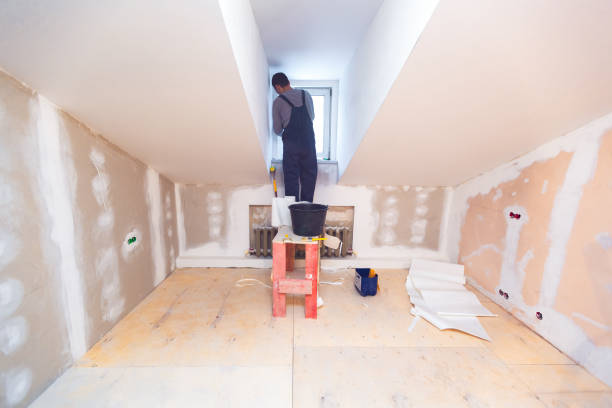 Worker is installing pvc window from wooden platform in small room of apartment that is under construction, remodeling, renovation, overhaul, extension, restoration and reconstruction. Concept of home improvement and renovate el trabajador está instalando la ventana de pvc de la plataforma de madera en una pequeña habitación de apartamento que está en construcción, remodelación, renovación, revisión, extensión, restauración y reconstrucción. concepto de mejoramiento