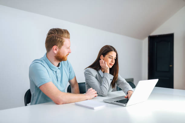 istock Two millennial business people working together in bright office. 1138463364
