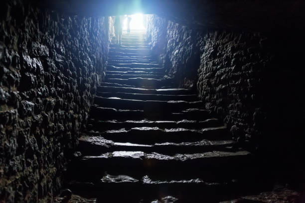 istock Underground passage under old medieval fortress. Old stone stairs to exit of tunnel 1138469736