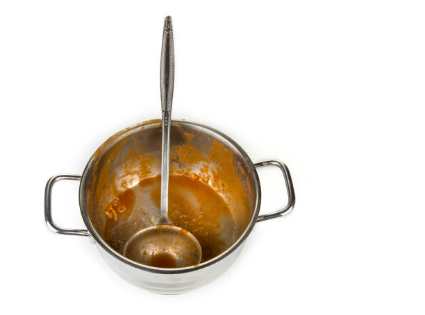 istock Dirty kitchen pot with ladle from a tomato soup 1138469920