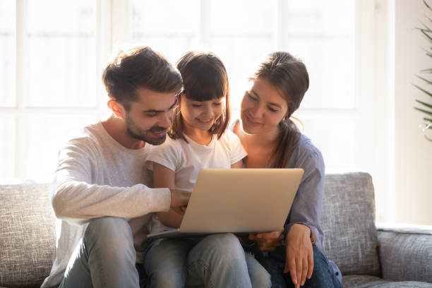 istock Happy family spending time at home browsing internet 1138470026