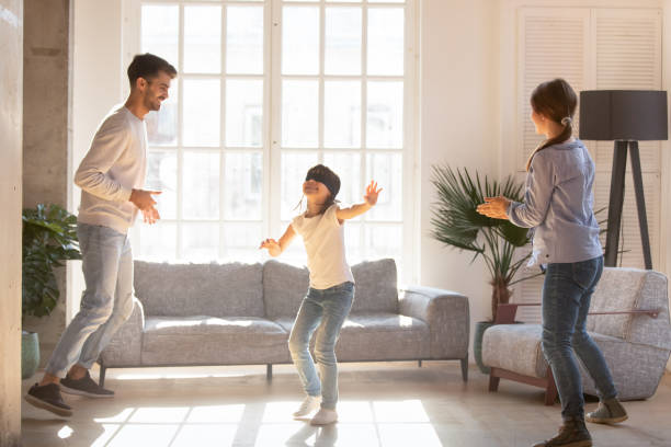 istock Blindfolded girl catching parents playing hide and seek game 1138470050