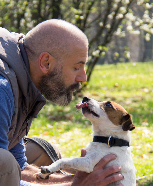 istock Man with a dog in the park, during early Spring time 1138471646