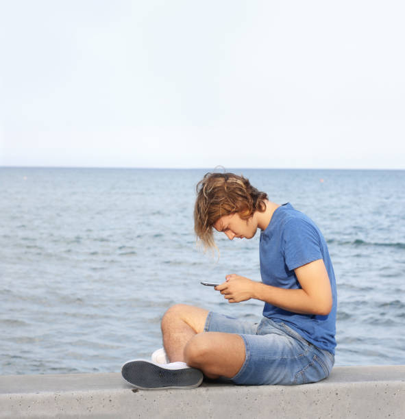 istock Teenage boy typing text message.Using smart phone. 1138478495