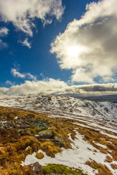 istock A view of snowy mountain slope under a majestic blue sky and white clouds 1138478917