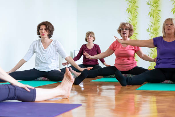 istock Senior women practicing  yoga in yoga studio 1138479647