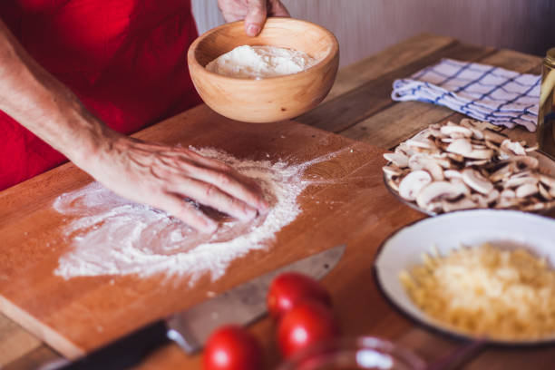 Home made pizza - pizza  dough stretching, close-up, selective focus