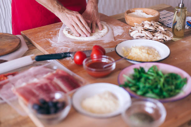 istock Making pizza at home, stretching pizza dough, close-up 1138481461