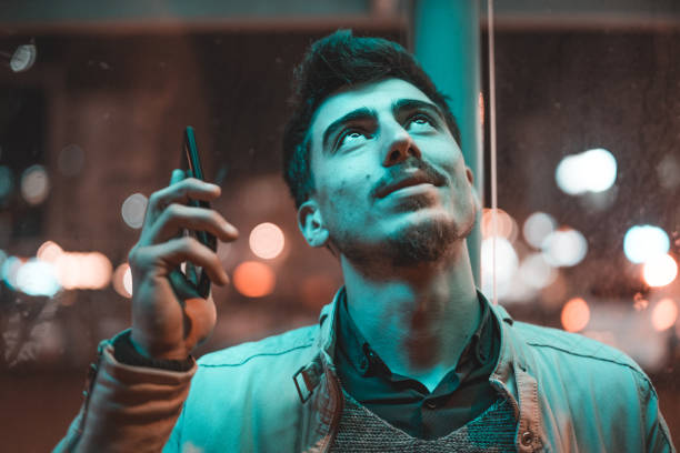 Young Man Calling On Mobile Phone At Night In City, Turkey