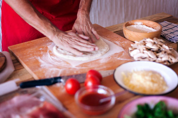 istock Making pizza at home, stretching pizza dough, close-up 1138482792