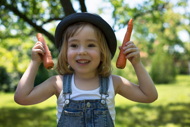 istock Little boy holding fresh organic carrots 1138483601