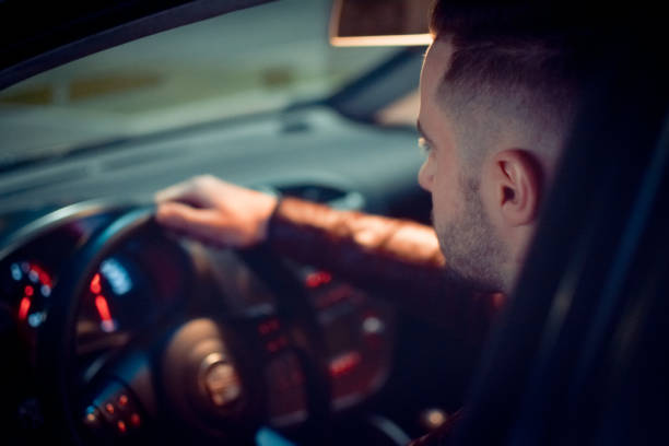 istock Man driving a car at night 1138483659