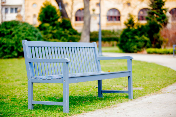 gray Bench in French style in a greenpark. Spring time season
