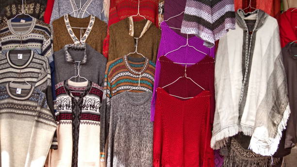 istock Sweaters and ponchos on hangers 1138486275