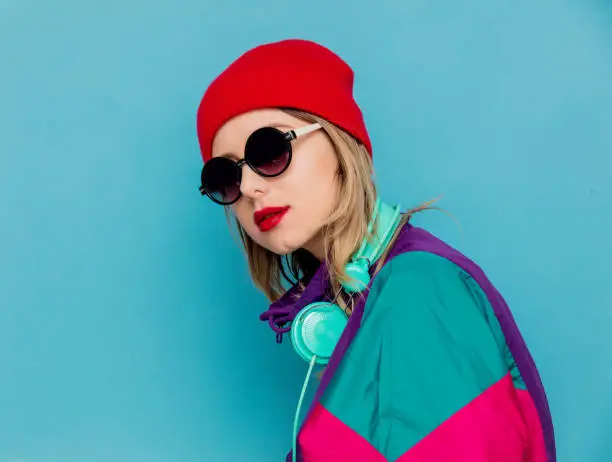 Photo of woman in red hat, sunglasses and suit of 90s with headphones