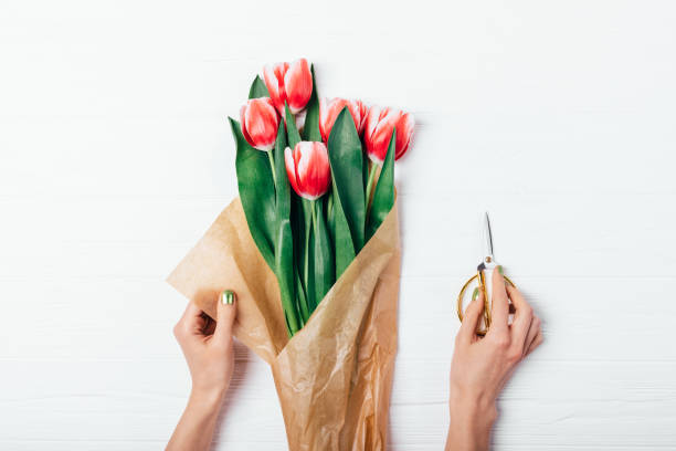 istock View from above female's hands wrapping bouquet 1138490169