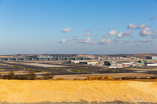 ISTANBUL, TURKEY - 24 MARCH 2019: Distant view of Istanbul Airport with a Turkish Airlines aircraft on the runway. When fully operational, Istanbul Airport will be among the largest airports.