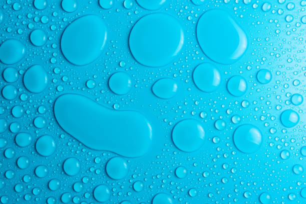 istock Droplets of water on a blue, matte background illuminated with a delicate light. 1138490811